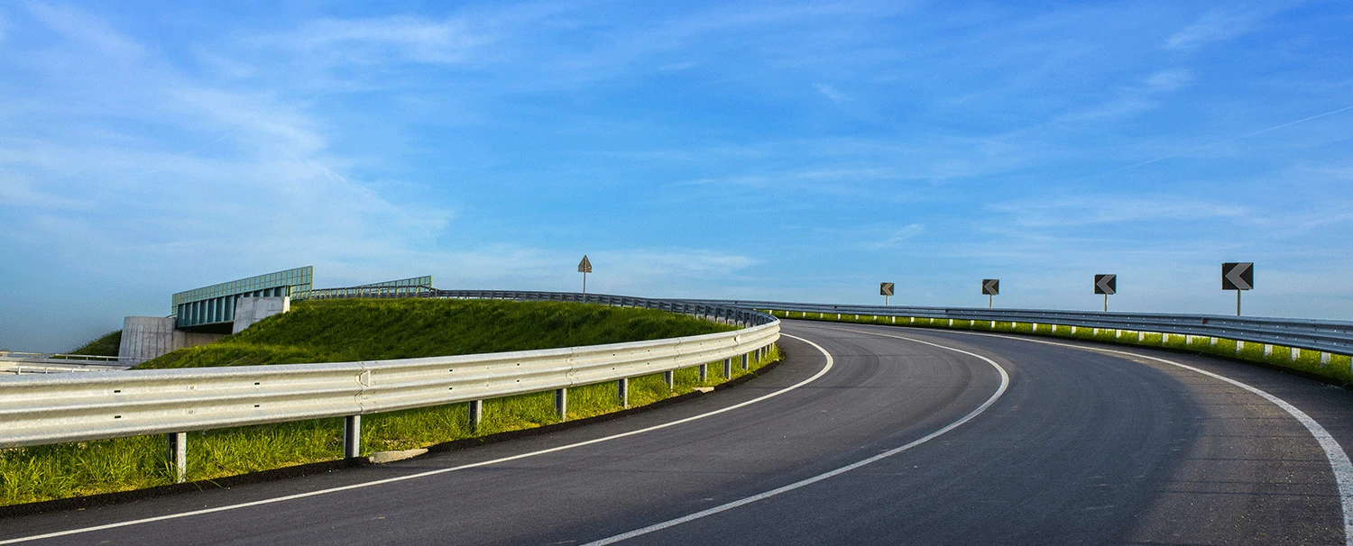 National highway with newly installed galvanised crash barriers and chevron sign boards